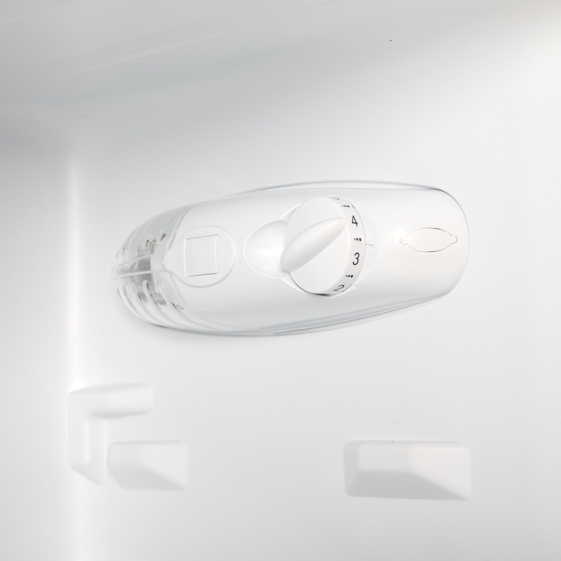 Temperature control dial inside a fridge freezer, showcasing settings for optimal cooling.